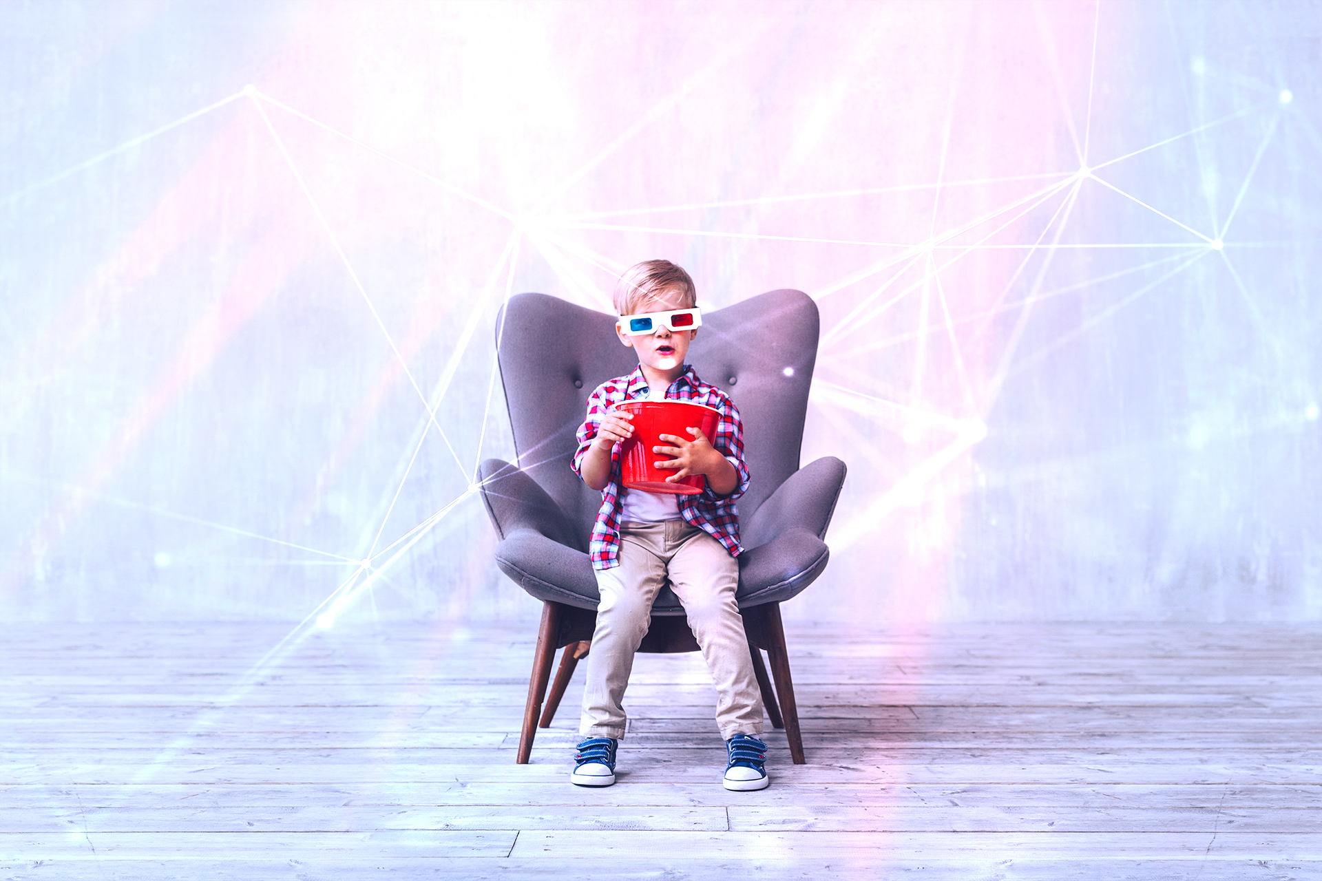 Pojke i fåtölj med 3d-glasögon och popcornhink